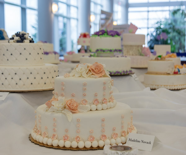 A colorful display of cakes in the library is among end-of-semester work by hospitality students.