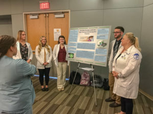 Student researchers compare bacteria growth on the hub of a central venous catheter using two different practices. From left: Sarah J. Schick, Ashlee N. Dick, Lauryn T. Howe, Timothy M. Osbourne and Elizabeth A. Stabley.
