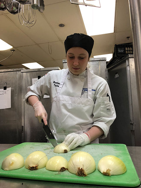 No tears: Bethany R. Taylor, of Moosic, cuts a seemingly endless supply of onions.