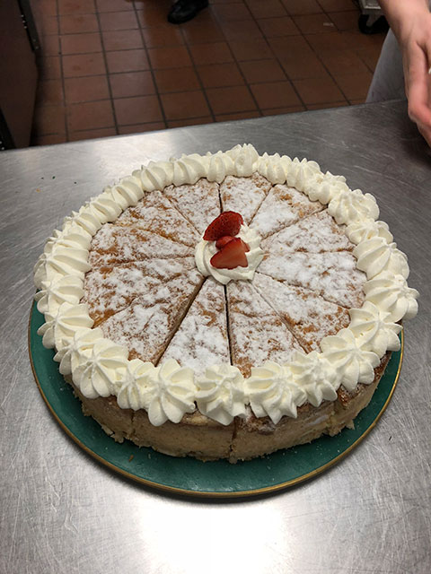 Hospitality students proudly decorated this cake moments before it was whisked into the Stakes Club for guests to enjoy.  