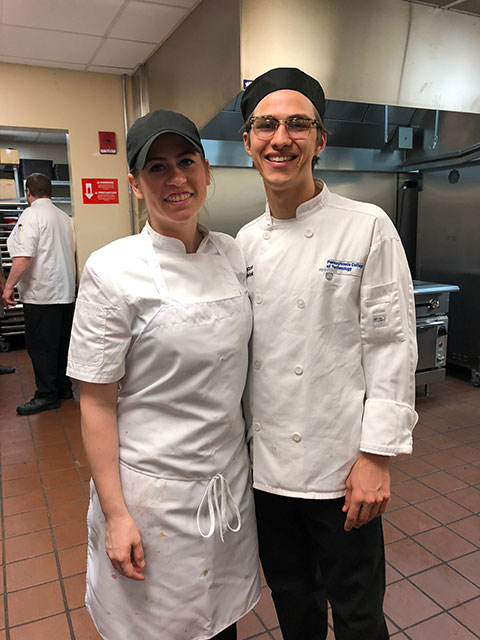 Alumna Victoria L. Kostecki and current student Jacob W. Parobek, of Seltzer, worked together all week in the Stakes Club kitchen. Parobek says all the workers became “like family.”