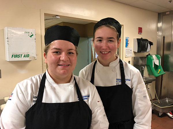 Nora E. Smith, of Centre Hall, and Sarah A. Bryan, of Bellefonte, take a respite from making salads in the Stakes Club kitchen.