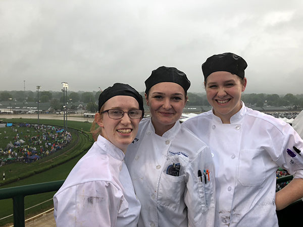 The pouring rain doesn’t dampen the spirits of alumna Dallas A. Tyree, current student Brittany L. Mink, of Allentown, and alumna Katlyn Hackling. 