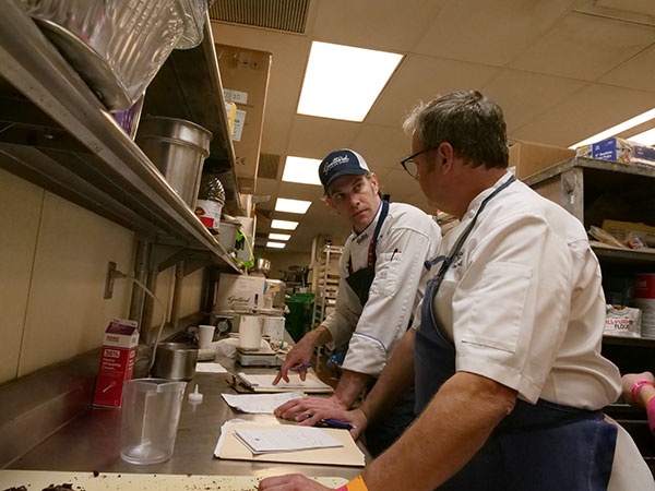 Niedermyer confers with Chef Donald Wressell, executive pastry chef at Guittard Chocolate Co., regarding the next day’s dessert options. 