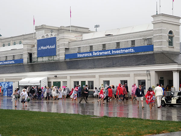 Steady raindrops force spectators to seek shelter on Derby Day.