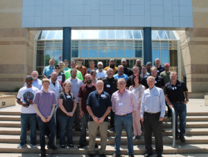 Industry representatives gather with their colleagues and workshop presenters outside the college's Breuder Advanced Technology & Health Sciences Center. (Photo provided)
