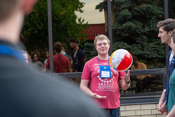 With the help of a beach ball featuring fun questions, an ASPIE camper enjoys a lighthearted ice-breaker.  