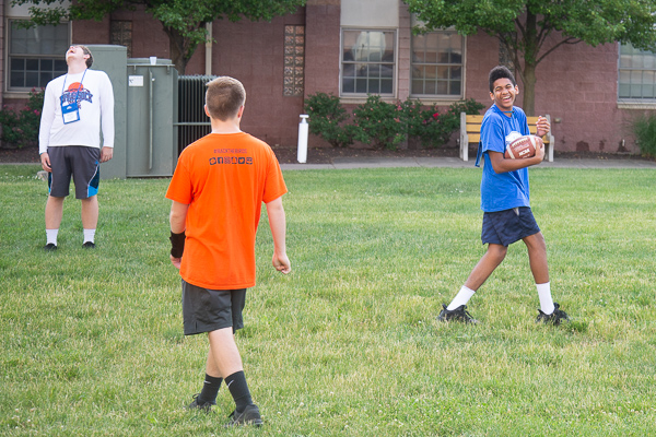 A pickup football game on the Rose Street Commons lawn