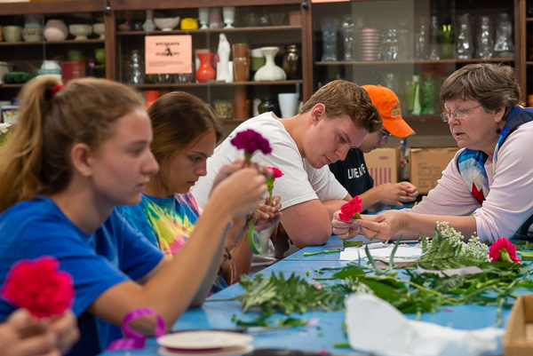 Crafting with carnations! Ruhl and campers work with floral tape to fashion boutonnières.