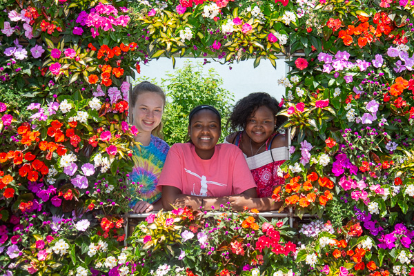 Framed by summer beauty are these SMART Girls at the floral feature outside College Avenue Labs.