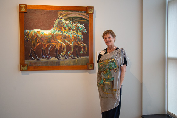 Artist Margaret Kemmerer, of Montoursville, donned a wrap matching her acrylic-on-slate painting, “Horses at St. Mark.” 