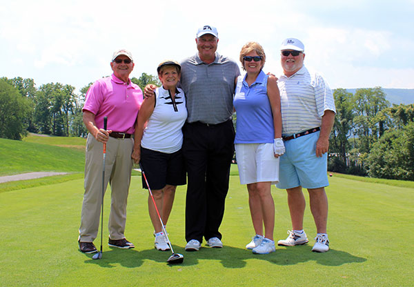 Boever cozies up with Ed and Linda Alberts (left), of Ralph S. Alberts Co. Inc., and Dave and Maggie Roche, of Roche Financial Inc., all longtime supporters of the event.