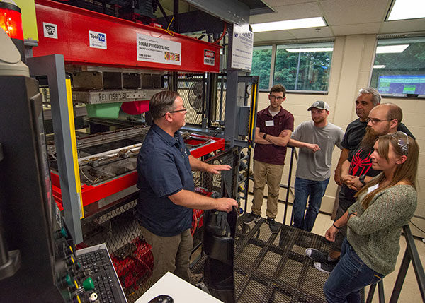 Program manager Christopher J. Gagliano (left) conducts a laboratory session in the Plastics Innovation & Resource Center's Thermoforming Center of Excellence.