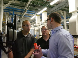 Yokitis and Hart discuss quality issues with Kevin Jant, senior manufacturing engineer.