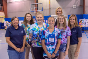 PPL Electric Utilities representatives Mary Baker (left), a forester for the company, and Tracie Witter, regional affairs director, gather with a team of campers who show off the robot they built during Penn College’s annual SMART Girls summer camp. PPL supported SMART Girls and the college’s dual-enrollment program through a $4,000 donation. Joining the group is Elizabeth A. Biddle (back row), director of corporate relations for the college.