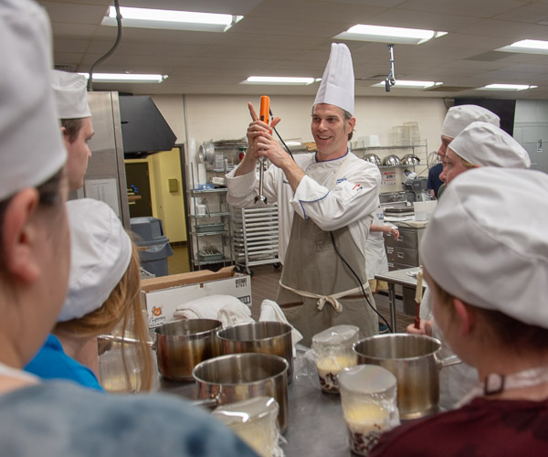 Niedermyer shows campers how to use an immersion blender to make ganache.