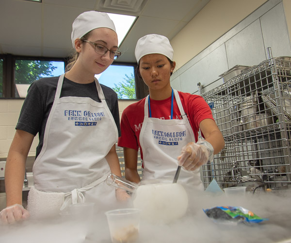 Future Restaurateurs campers get a hands-on science lesson as they flash freeze snack foods in liquid nitrogen.