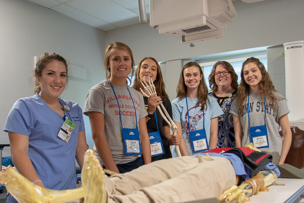 Campers take a break from positioning their “patient” for an X-ray. Included in the photo are Tiana F. McCormick (left) of Williamsport, who is scheduled to earn an associate degree in radiography in August, and Karen L. Plankenhorn (second from right), clinical supervisor of radiography.