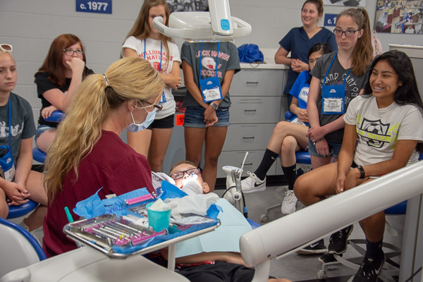 Tammy S. Clossen, assistant professor of dental hygiene, discusses the work of a registered dental hygienist while demonstrating a typical prophylaxis session.