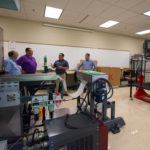State Rep. Kurt Masser (in purple shirt) and Harold Hurst (left) his chief of staff, visit the Thermoforming Center of Excellence with Christopher J. Gagliano (second from right), PIRC program manager, and Christopher P. Ray, executive director of business development at Penn College.