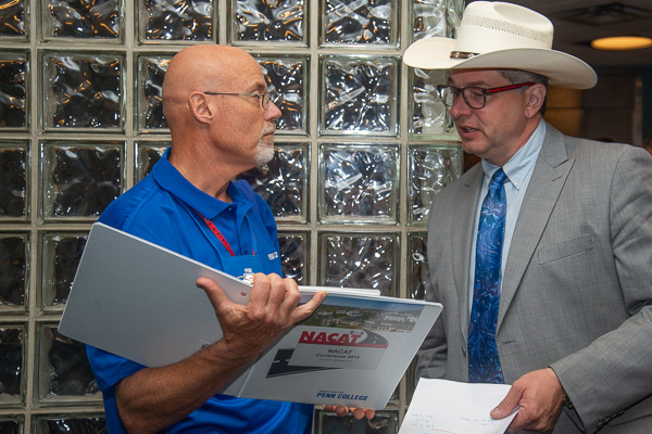 A veteran of many NACAT conferences, Dale E. Jaenke (left) – soon to retire after 22 years on the college's automotive faculty – talks with council President Patrick Brown-Harrison.