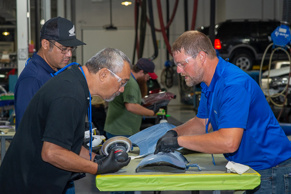 Collision repair instructor Loren R. Bruckhart (right) oversees a hands-on exercise by University of Hawai‘i Maui College faculty members Thomas K. Hussey (foreground) and Lawrence K. Martinson in the 