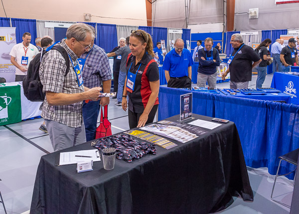 Juliet Marshall, of Specialty Equipment Market Association, engages a visitor.