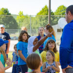 Jeremy R. Bottorf (right), coordinator of athletics for club sports, intramurals and camps, raises the bar in the "Who can blow the biggest bubble?" contest.