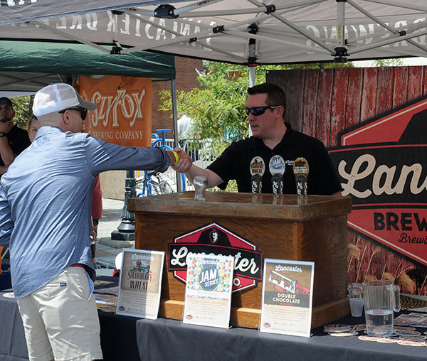 Patrick Marty (left), chief of staff/assistant to the president for college relations, gets acquainted with representatives of the Lancaster Brewing Co.