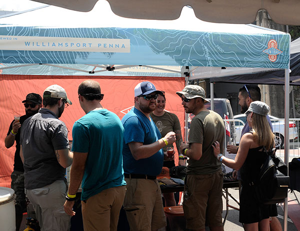 After a seeming eternity of rain, patrons soak up sun and suds – including the well-received creations of the New Trail Brewing Co. from the college's Newberry backyard.