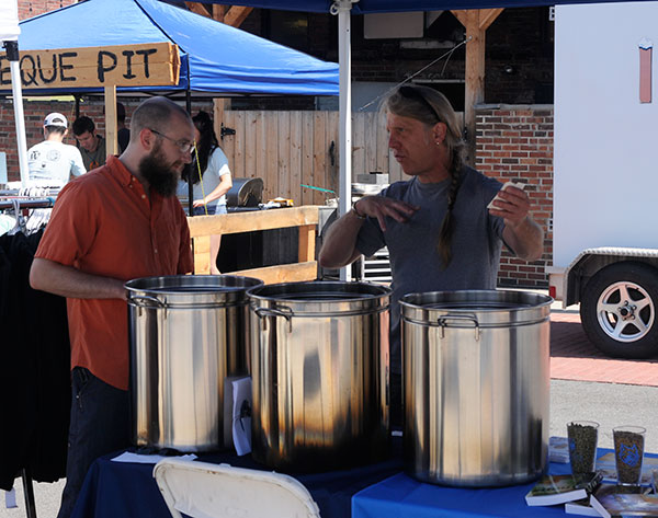 Timothy L. Yarrington (right), instructor of brewing and fermentation science at Penn College, sets up a Brewfest display with student Ryan J. Hampton, of Williamsport ...