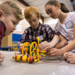 A group from New Covenant Academy in Mansfield makes final adjustments to its wearable back massager during a STEM Design Challenge hosted by BLaST Intermediate Unit 17 in the college’s Field House.