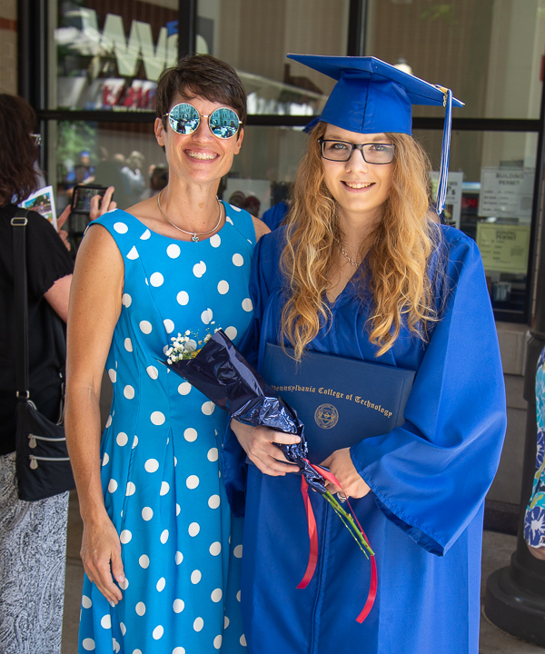 Wildcat blue accessories abound for Bambi A. Hawkins, left, learning laboratory coordinator for the emergency medical services/paramedic program, and new graduate Gabrielle E. Hileman, of Hughesville, emergency medical services. 