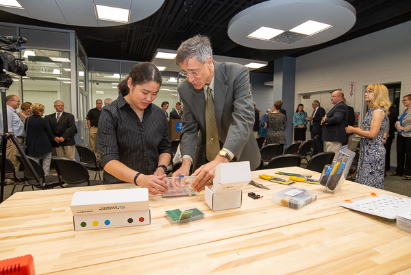 Prior to the dedication, Thomas E. Ask, professor of industrial design, explores ideas with Nina M. Hadden, an industrial design student from Murrysville. Hadden designed the 3D-printed saw blade and tools presented by President Gilmour to Welch. Ask initiated the idea of a Makerspace at the college. 