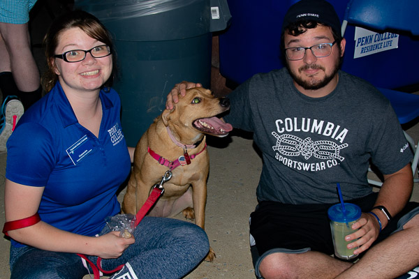 With Outdoor Movie Night coincidental to National Dog Day, Student Activities Event Assistant Cas D. Henderson and Resident Assistant Kyle T. Hansen hang out with a friend.