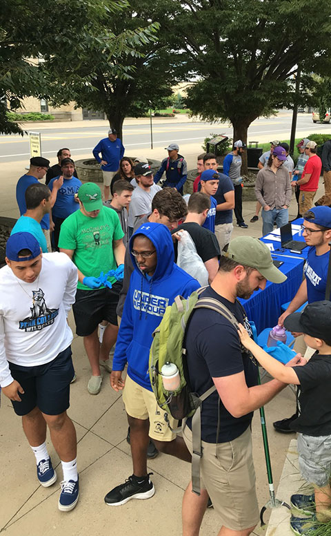 A horde of helpers awaits dispersal outside the Klump Academic Center.