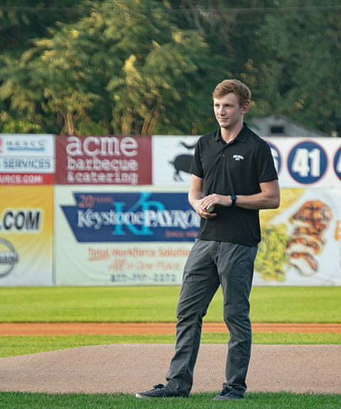 Thomas S. Runner, a member of the Wildcat cross-country team and Male Scholar-Athlete of the Year for 2018, prepares to throw out a ceremonial pitch ...