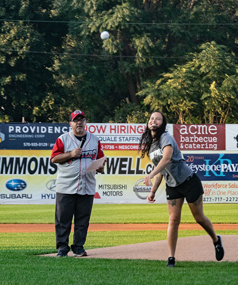 ... followed by Taylor A. Krow, a softball player and 2018's Female Athlete of the Year, joined on-field by Gabe Sinicropi Jr., the team's vice president for marketing.