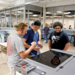 The hands-on allure of the facility is evident as attendees move among the equipment ...