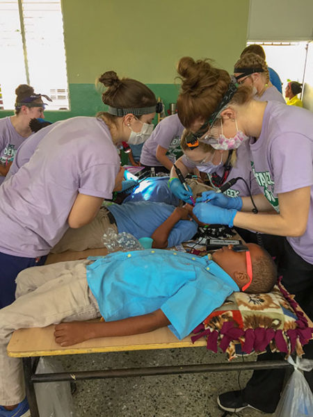From left, Penn College dental hygiene students Megan M. Mecouch, of Peach Bottom, Lancaster County; Kayla C. Summerson, of Emporium, Cameron County, and Lori M. Weaver, of Newmanstown, Lebanon County, join classmates in cleaning children’s teeth at a school in the Dominican Republic.