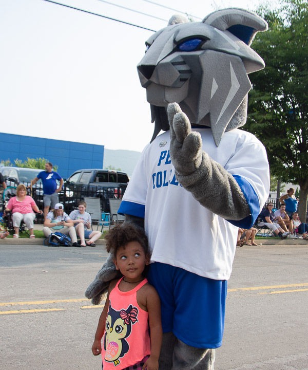 A young parade-goer gives the Wildcat a second look while posing for a photo.