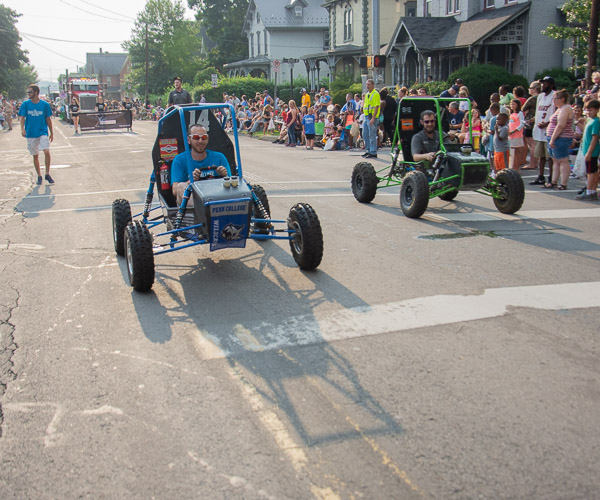 Student-designed and -manufactured Baja vehicles sprint through the parade route.