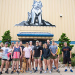 "Sky's out, thighs out!" Honoring that reminder to ditch long pants and don running shorts in good weather, some participants in the veteran-sponsored 5K pose in front of the Field House.