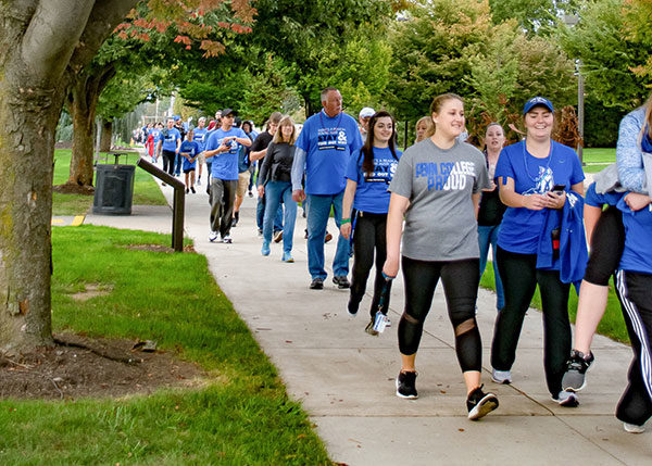 Walkers, many of them clad in Wildcat blue, fill the Penn College mall during 2017’s Ouf of the Darkness event. (Photo by Rachel A. Eirmann, student photographer)
