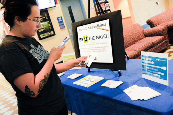 Morgan K. Ebersole, a graphic design major from Martinsburg, stops by the "Be the Match" display near the CC elevator. (Photo by Rachel A. Eirmann, student photographer)