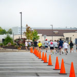 And they're off! Runners (pace dog included) round the corner near the new water feature outside College Avenue Labs.
