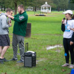 Pace, a second-place finisher in his age group, receives a medal ... and the students' gratitude for his support of their initiative.