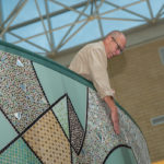 Stabley points out the intricacy of his creation's colored glass tiles.