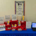 A library display includes facts, giveaways ... and a laptop for self-service voter signup.