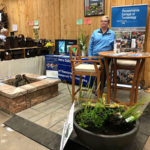 Rhonda S. Walker, alumni relations specialist, prepares to engage Thursday's visitors to the horticulture booth ...